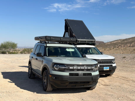 Two Ford Bronco Sport SUVs with rooftop tents, ready for your next rv rental camping adventure in the desert.