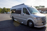 Silver Mercedes-Benz Sprinter RV rental: a sleek camper van parked on a sunny day.