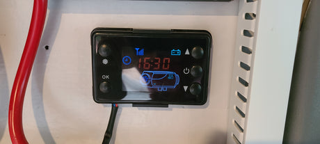 RV rental cabin heater's digital control panel showing 16:30. Essential for comfortable van life and camping.