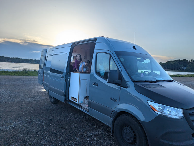 Kids enjoy an RV rental campervan by a serene lake at sunset, perfect for family adventures and van life. — photo 14