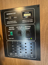 RV rental control panel: generator, water heater, water pump (on), and tank levels for water, gas, and battery charge.
