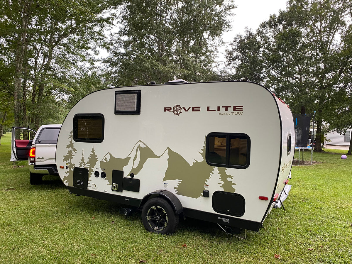 A Rove Lite (Built By TLRV) travel trailer, ideal for an RV rental, is parked on green grass with a truck nearby. — photo 2