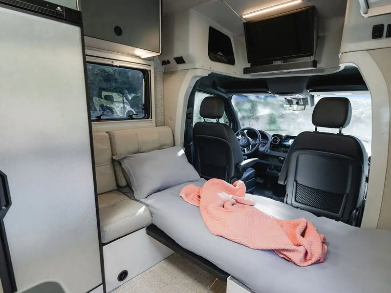  and clear forest views from large windows.|Cozy RV rental interior with two single beds — photo 13