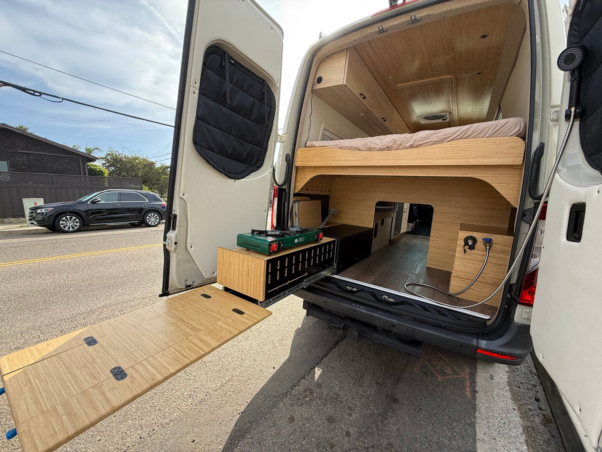  and overhead cabinets with strip lighting.|Modern rv rental interior showcasing a cozy bed — photo 4