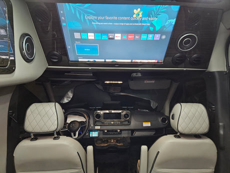 Spacious rv rental interior featuring a large entertainment screen with streaming apps like Netflix and a modern dashboard.