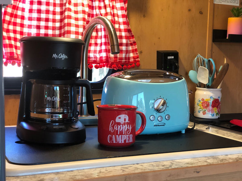 Essentials for your RV rental: a Mr. Coffee maker, Brentwood toaster, and a cozy "happy CAMPER" mug in the kitchen. — photo 10