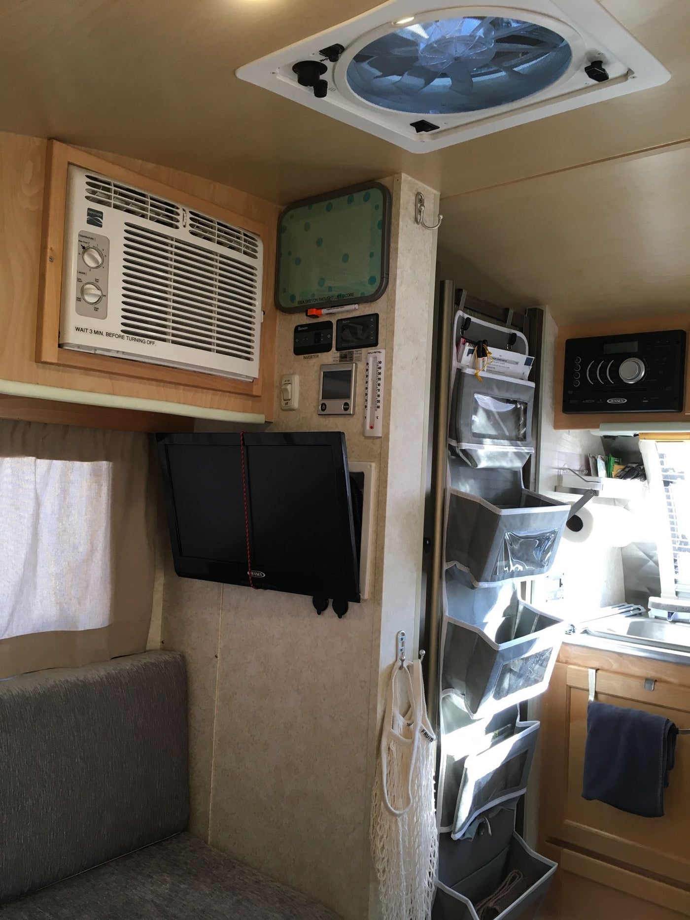  featuring a fun 'Happy Camper' spare tire cover.|A grey teardrop travel trailer — photo 18