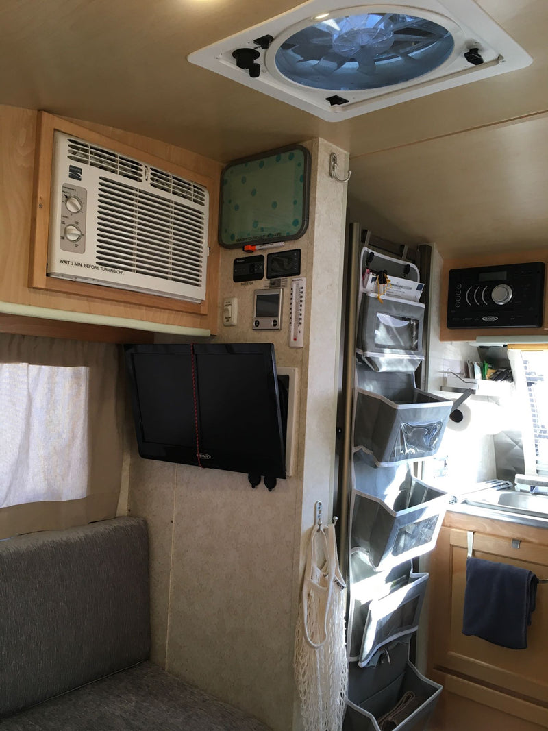  featuring a fun 'Happy Camper' spare tire cover.|A grey teardrop travel trailer — photo 18