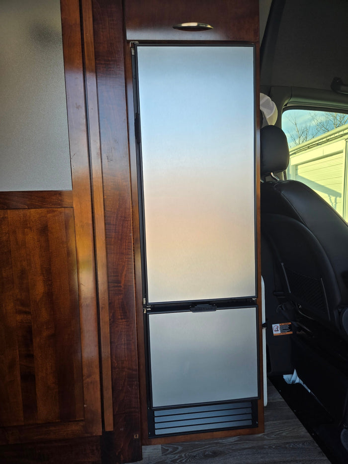  and drain in a white fiberglass unit.|Compact RV rental bathroom featuring a modern handheld shower