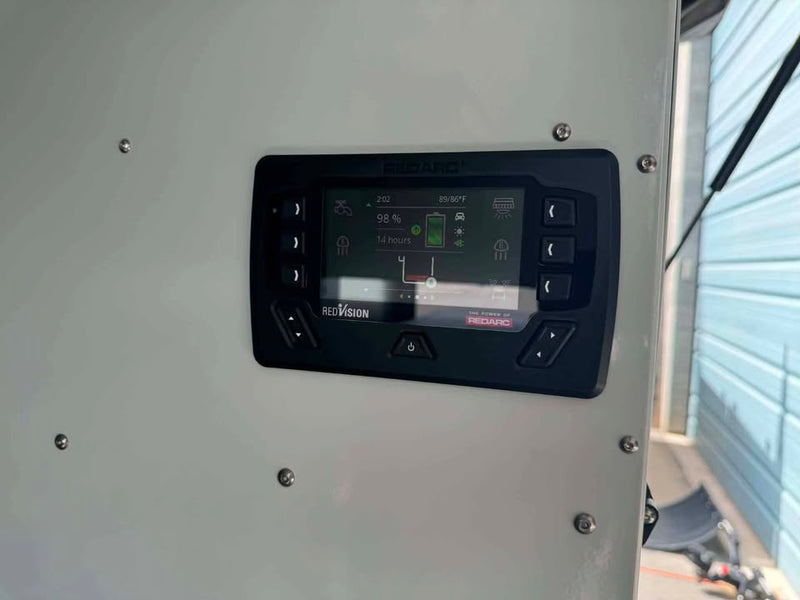 Redarc RedVision system display mounted on the interior wall of the XPedition Voyager Sky XE, showing 98% battery charge and 14 hours remaining — photo 12