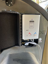 Eccotemp portable water heater & outdoor shower unit for an RV rental, offering convenient hot water.