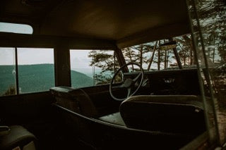 From inside a classic SUV, scenic mountain vistas unfold. Envision your next RV rental journey through stunning landscapes.