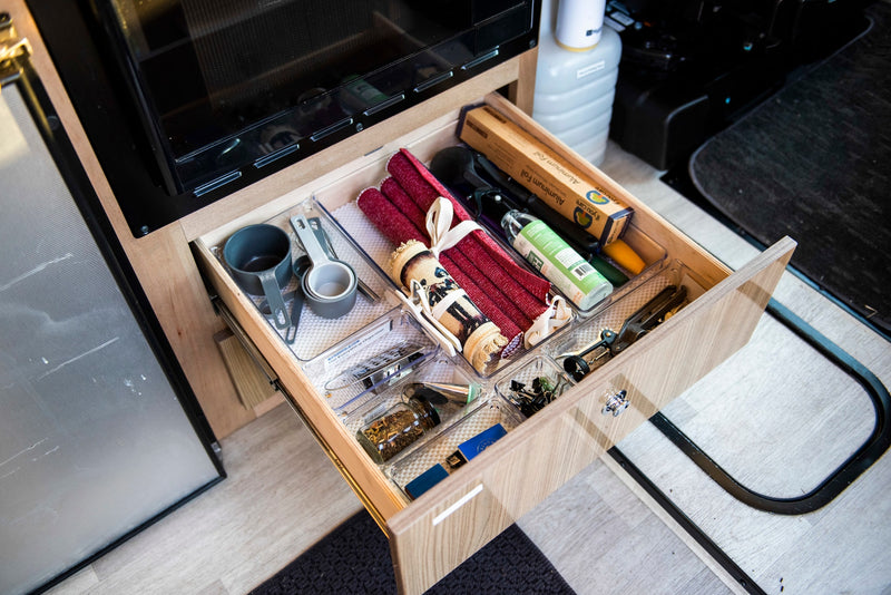 RV rental kitchen drawer, perfectly organized with cooking essentials: foil, measuring cups, and various utensils. — photo 7