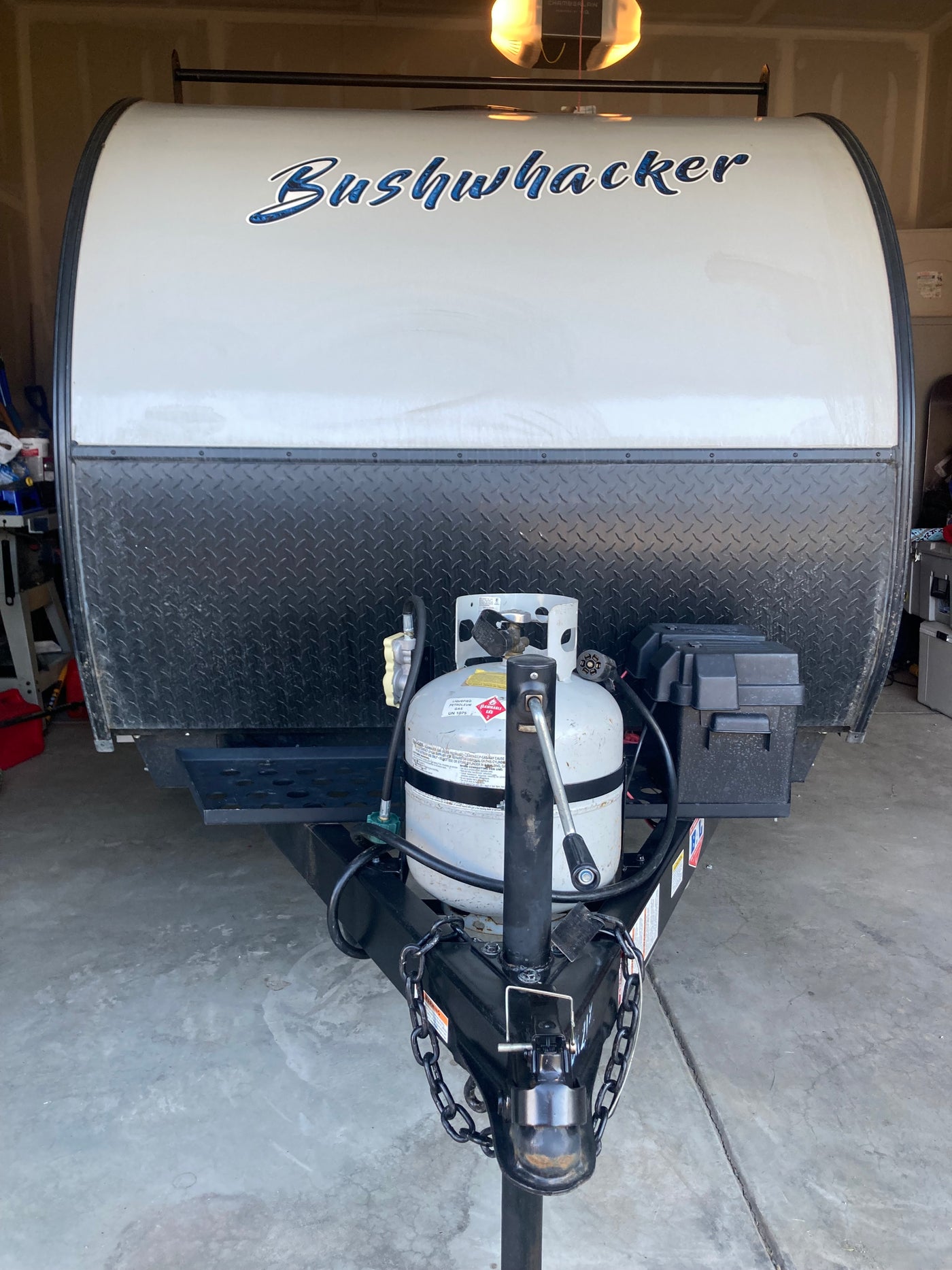 Front of a Bushwhacker travel trailer, ideal for an **rv rental** adventure. Features propane tank & hitch. — photo 13