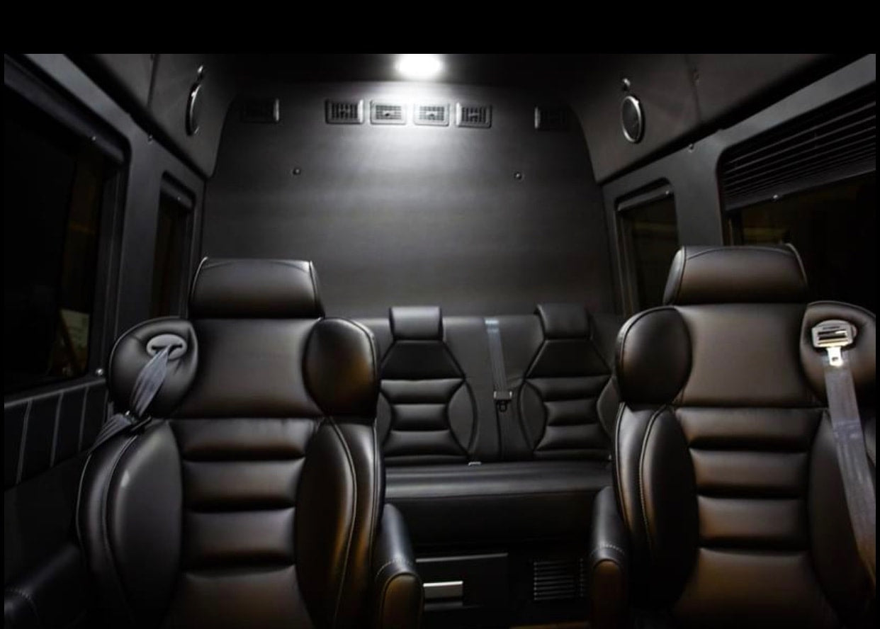 Spacious, dark RV rental interior with plush black leather seats, perfect for luxury travel. — photo 2