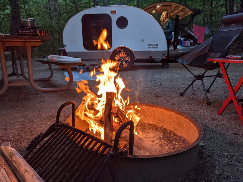  and compact amenities.|Cozy RV rental interior featuring a comfortable bed — photo 9