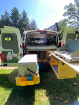 This RV rental van features a cozy bed and a pull-out kitchen, perfect for your next camper van adventure.