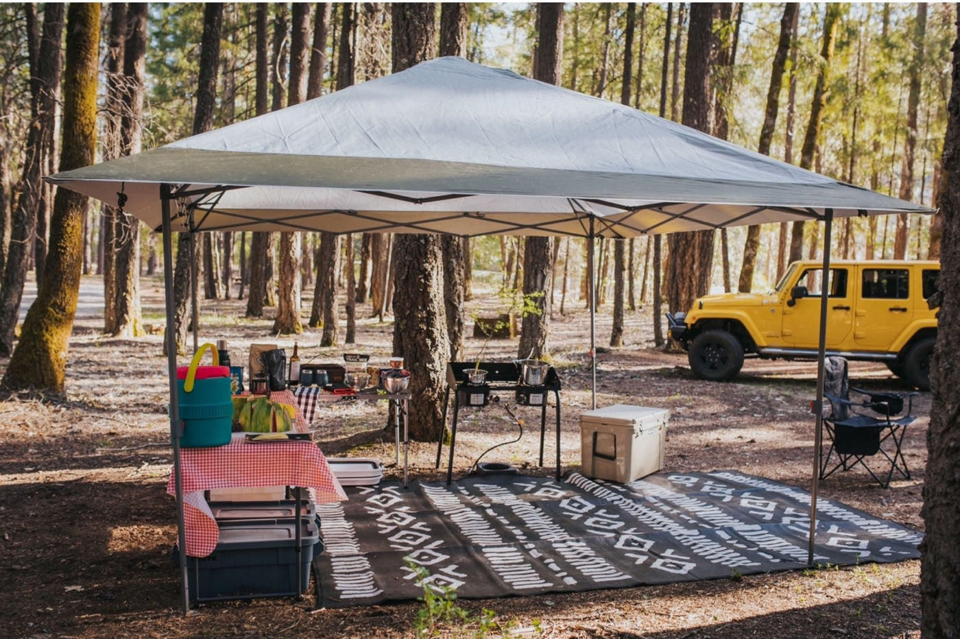  and cleaning tools. Efficient packing for your adventure.|Family unloads a spacious RV rental adventure trailer in the forest — photo 6