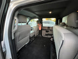Inside an rv rental: a spacious grey rear cabin with comfortable seats and ample floor space, seen from the open door.