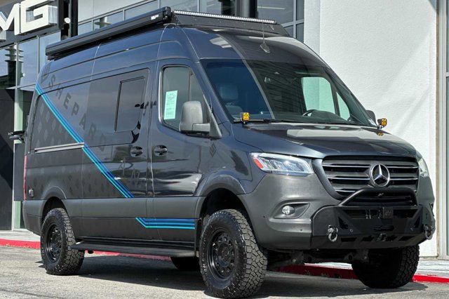  is ideal for RV rental.|A rugged black Mercedes Sprinter adventure van with a ladder — photo 6