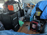 RV rental interior featuring a Jackery power station, BOXIO sink, and Mr. Heater, ready for mobile adventures.