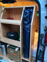Organized camper van interior with custom wooden storage, an RTIC cooler, and cooking gear. Great for rv rental adventures!