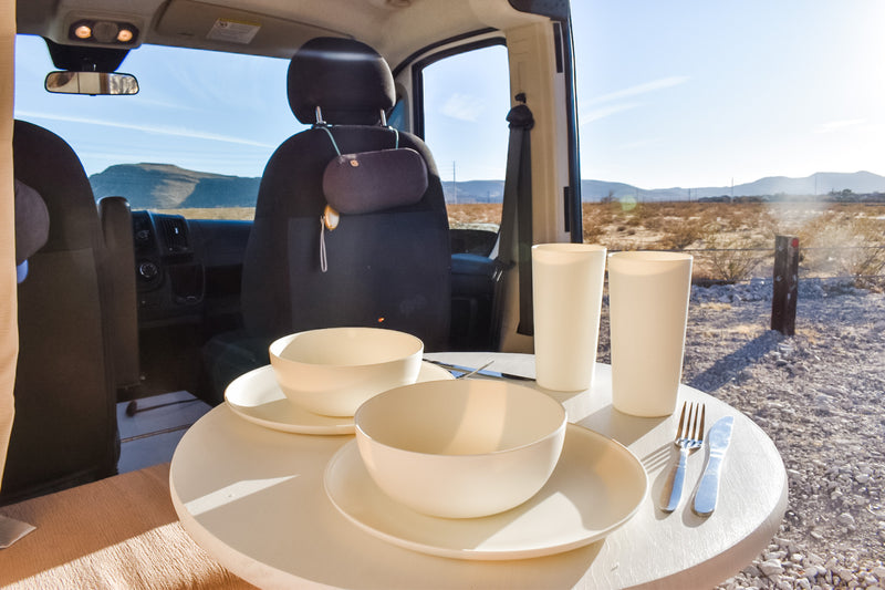 RV rental adventure: Outdoor dining from a camper van in a sunny desert landscape, table set for two. — photo 16