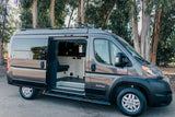 Grey Tofino Ram ProMaster camper van rv rental. Side door open shows custom interior, ready for your next adventure.