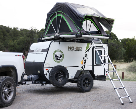 This Forest River No Boundaries trailer, equipped with a roof tent and towed by a 4x4, is an ideal rv rental for off-grid camping.
