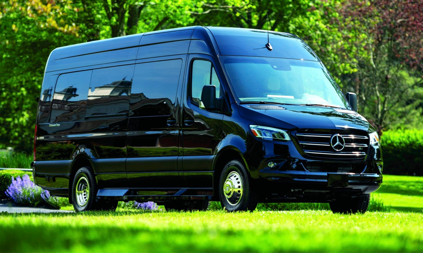 Black Mercedes-Benz Sprinter van on a lush green lawn. Ideal for a spacious and luxurious RV rental experience.