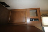 RV rental interior: overhead cabinet with built-in stereo and storage cubby for entertainment & convenience.