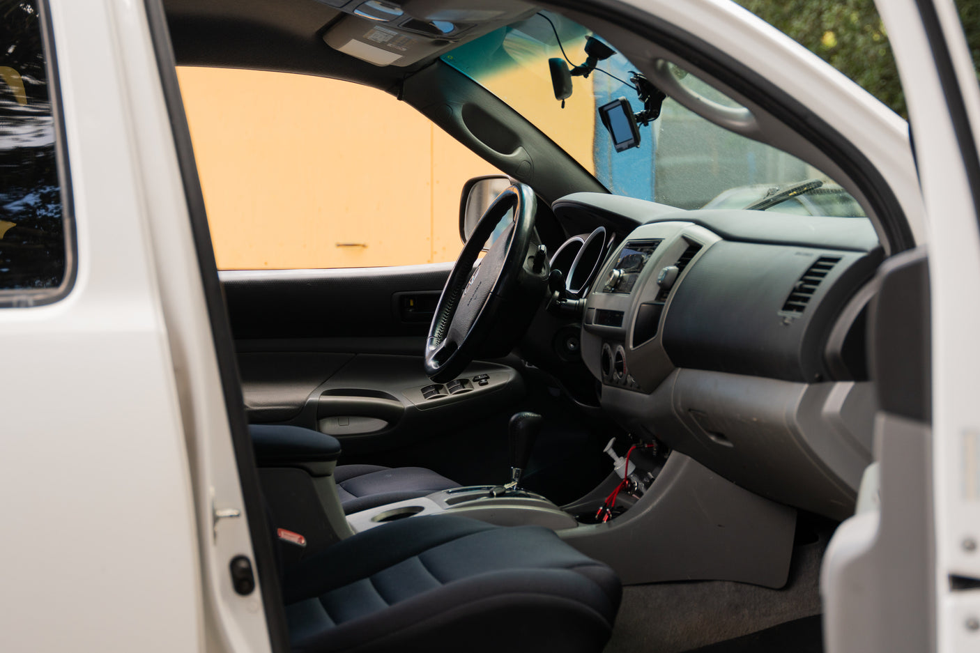 Interior of a white truck cabin, featuring a clean dashboard and seats. Consider this truck for your next RV rental adventure.