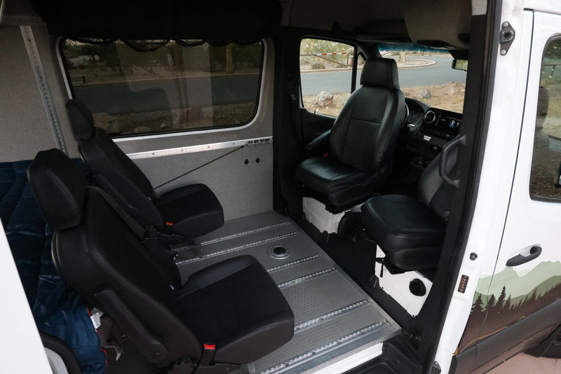 View inside a spacious RV rental, featuring adaptable black seating on a versatile modular track floor system. — photo 14