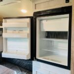 Inside your rv rental: an open, empty refrigerator and freezer, perfect for storing road trip essentials. Ready for your adventure. — photo 8
