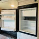 Inside your rv rental: an open, empty refrigerator and freezer, perfect for storing road trip essentials. Ready for your adventure.