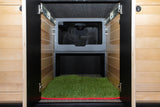 RV rental: Dedicated pet space with artificial grass mat, offering a built-in relief area with ventilation.