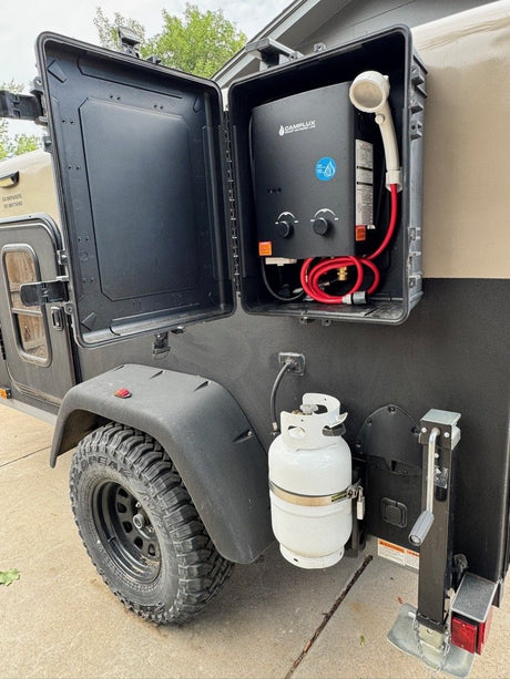 Exterior utility door with propane water heater and shower hookup