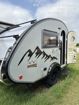 This nuCamp T@B 320 Boondock teardrop rv rental, a compact camper, is ready for adventure, parked on grass.