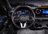 Comfortable RV rental interior: A Mercedes-Benz steering wheel and modern dashboard with digital displays and infotainment system.