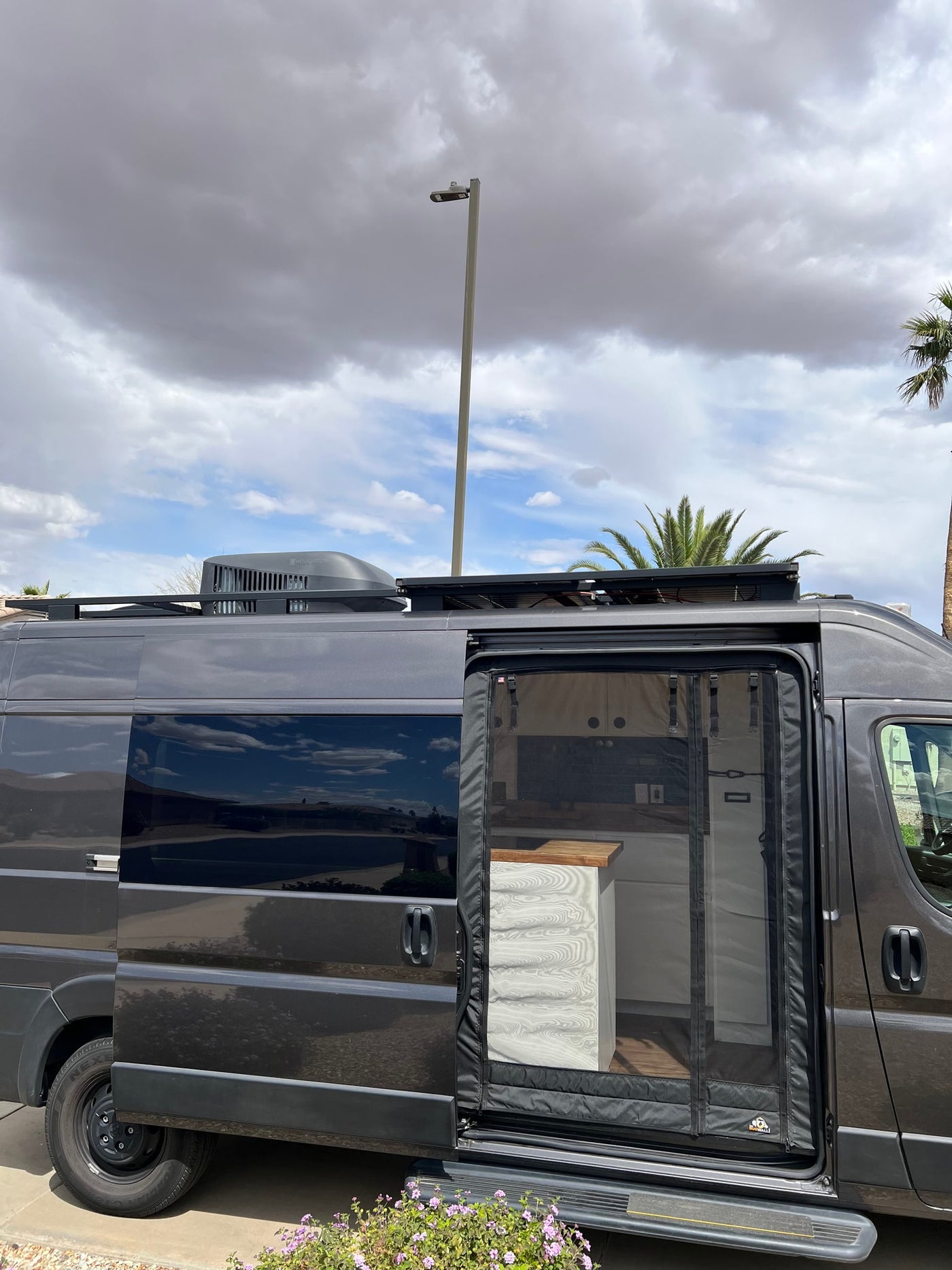  and white paneling.|Modern RV rental kitchenette in a camper. Features a dark green tile backsplash — photo 4