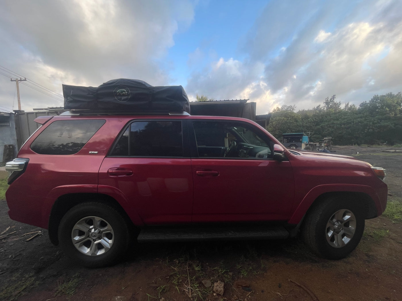Red 4Runner with rooftop tent, parked on dirt. Explore this adventure vehicle for your next RV rental trip. — photo 8