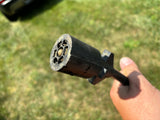 Close-up of a 7-pin RV trailer electrical connector, vital for powering your RV rental.