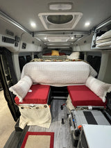 Inside this RV rental: a plush bed, modular seating, and a portable fridge make for comfortable van life.