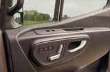 RV rental vehicle's driver's door panel featuring power seat controls with memory, door locks, and window switch.