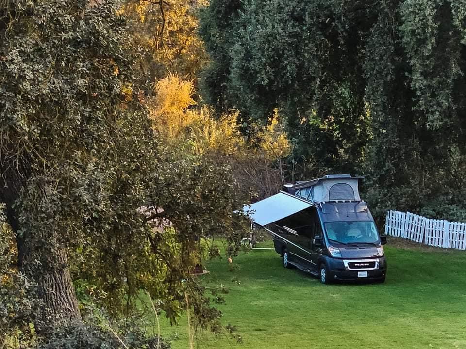  and cargo box on a green lawn.|Moonlit night camping with an RV rental — photo 7