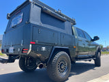 This robust truck camper, part of an RV rental fleet, is equipped for rugged overland trips.