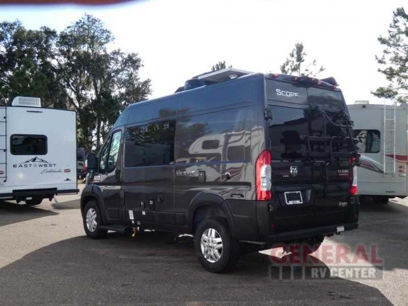 Dark Class B camper van (Scope) with solar panels, an ideal RV rental option, parked with other RVs. — photo 5