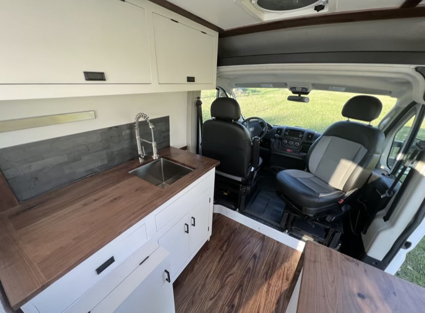  ideal for RV rental. Parked on a rural gravel road.|Efficient rv rental storage: Rear pull-out trays in a camper van conversion — photo 4