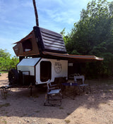 Experience outdoor adventure with this off-road teardrop rv rental trailer, featuring a roof-top tent and awning for comfortable camping.
