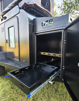 This black OTG camper/RV rental features a convenient slide-out storage tray & shelving for camping gear.
